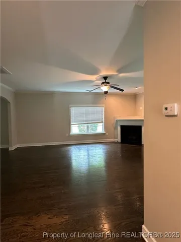 a view of a livingroom with a ceiling fan and window