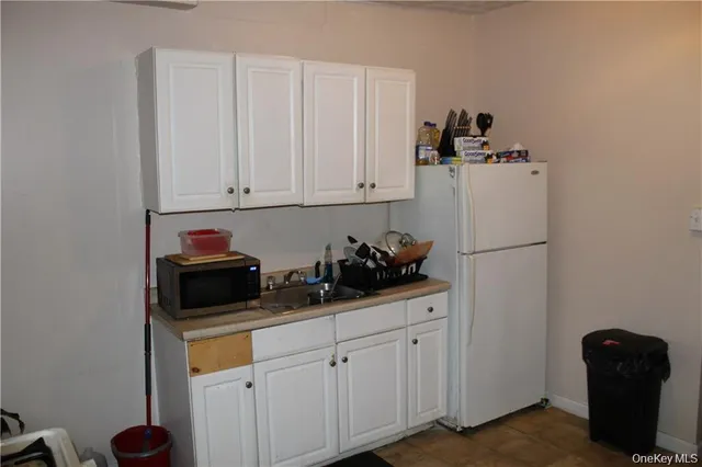 a kitchen with a refrigerator and cabinets