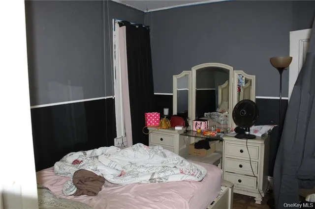 a bedroom with a bed and a dresser