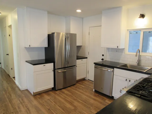 a stove top oven sitting inside of a kitchen