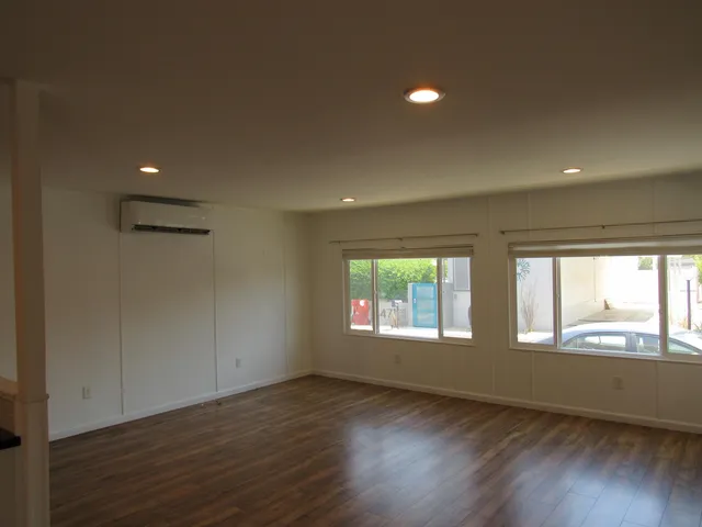 a view of a kitchen with a sink and wooden floor
