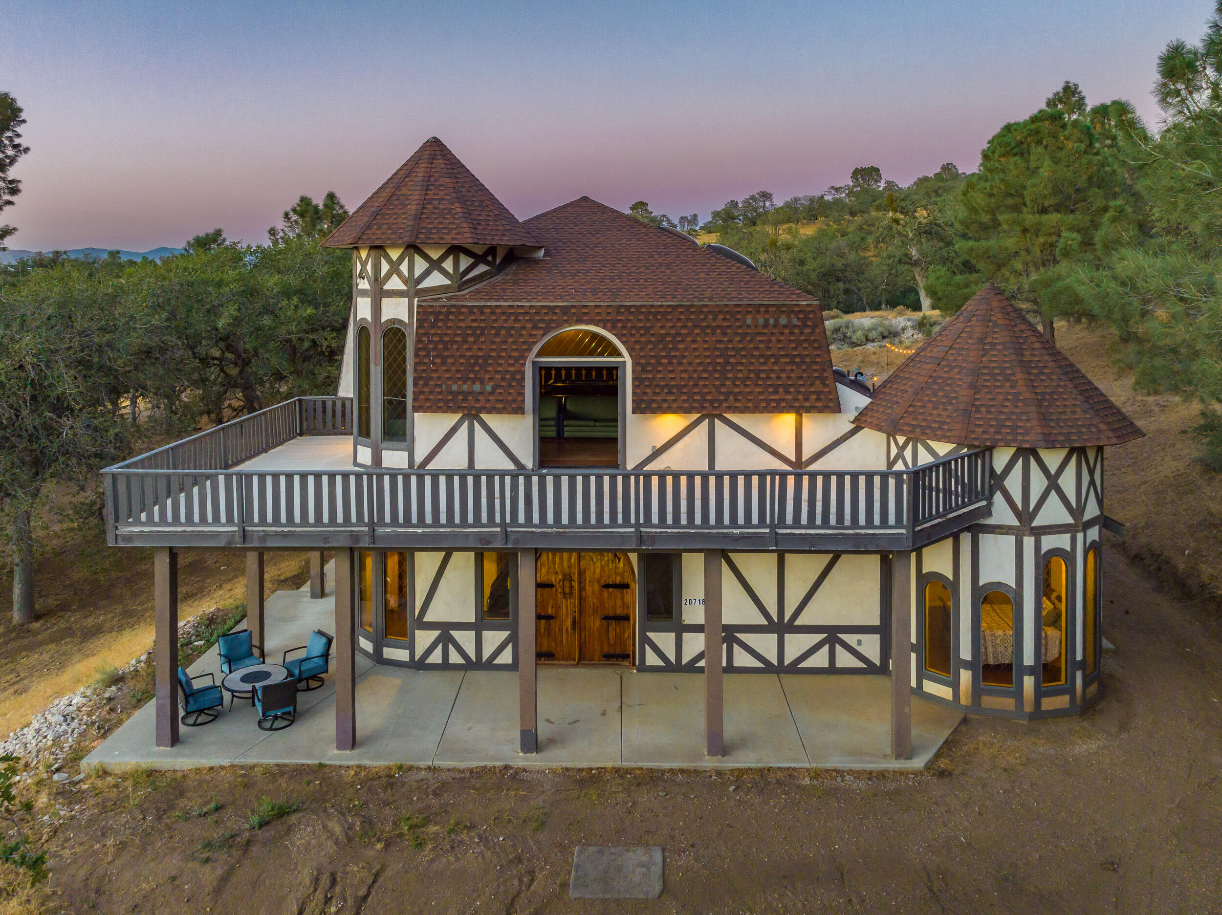 an roof deck with table and chairs under an umbrella with wooden floor