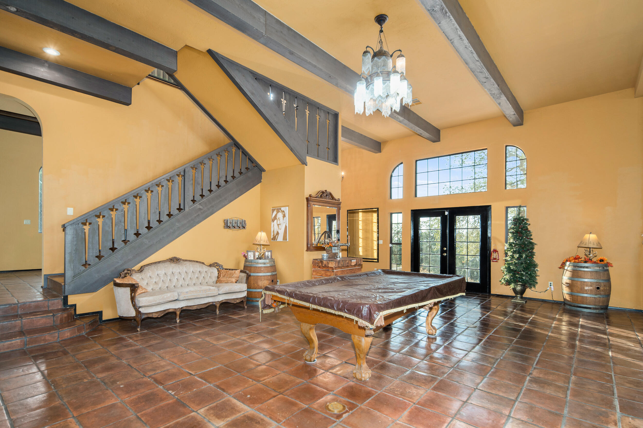 20718 Darsy Road Tehachapi, CA 93561 - Photo 15 of 64 a living room with stairs and a table with wooden floor