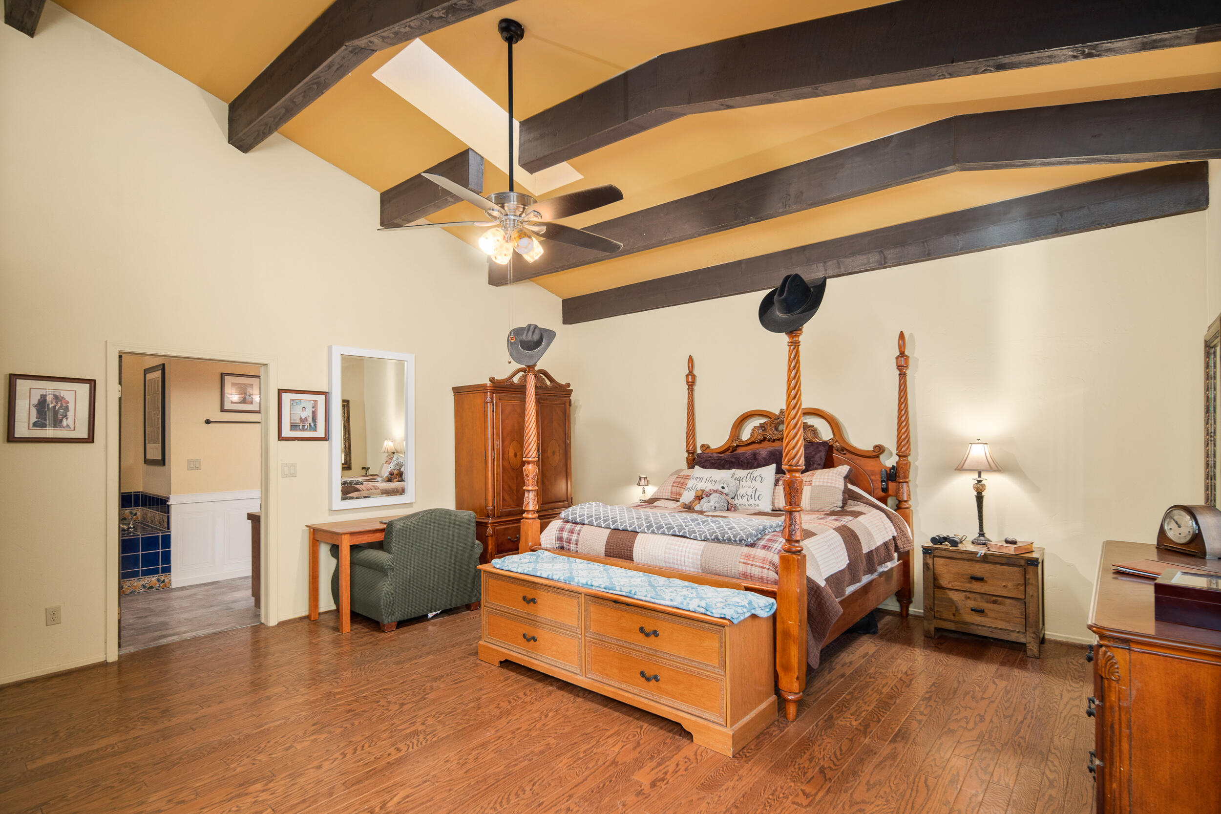 20718 Darsy Road Tehachapi, CA 93561 - Photo 26 of 64 a bedroom with bed and a chandelier