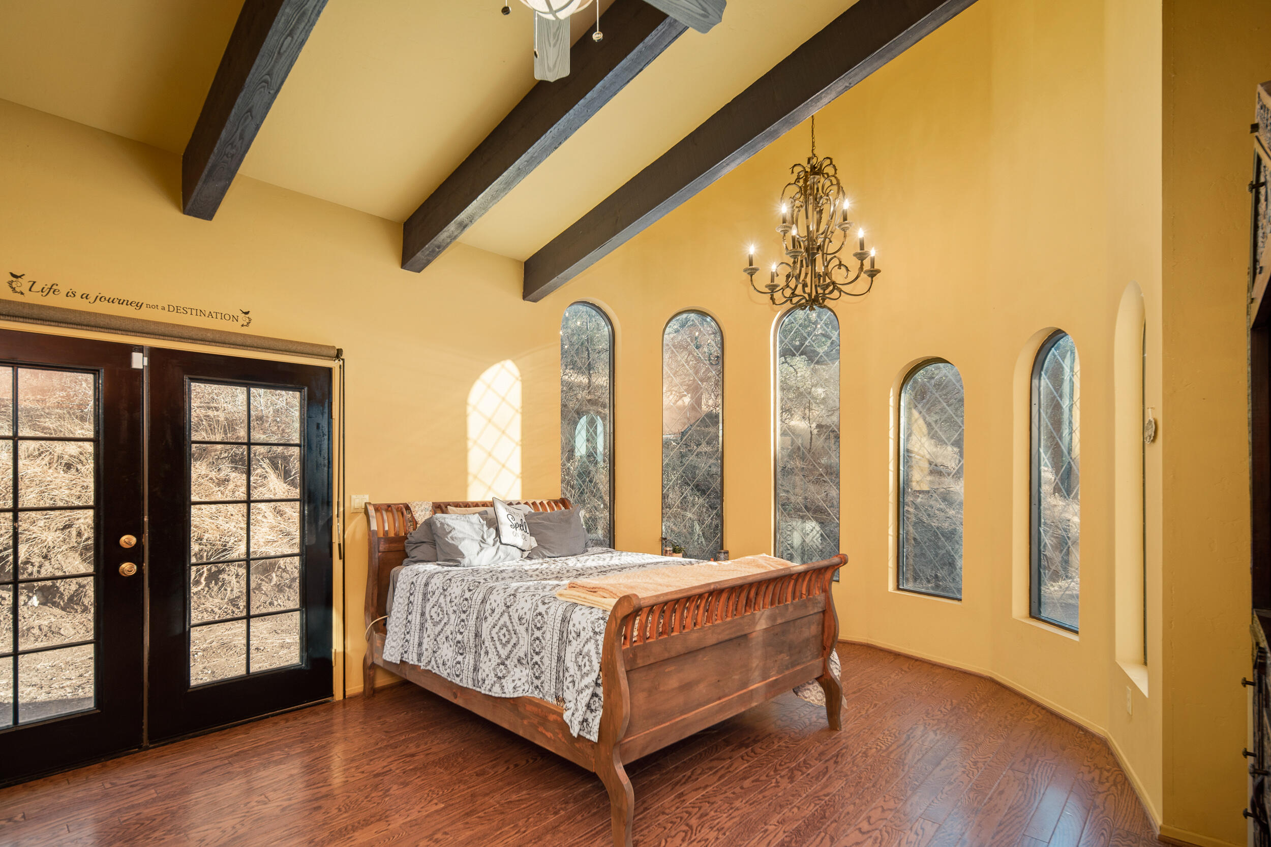 20718 Darsy Road Tehachapi, CA 93561 - Photo 31 of 64 a bedroom with a large bed and two windows