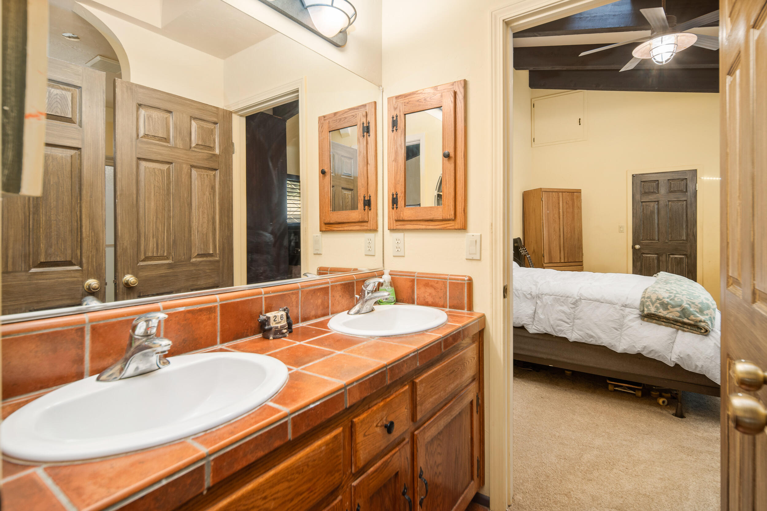 20718 Darsy Road Tehachapi, CA 93561 - Photo 35 of 64 a bathroom with a double vanity sink and a mirror