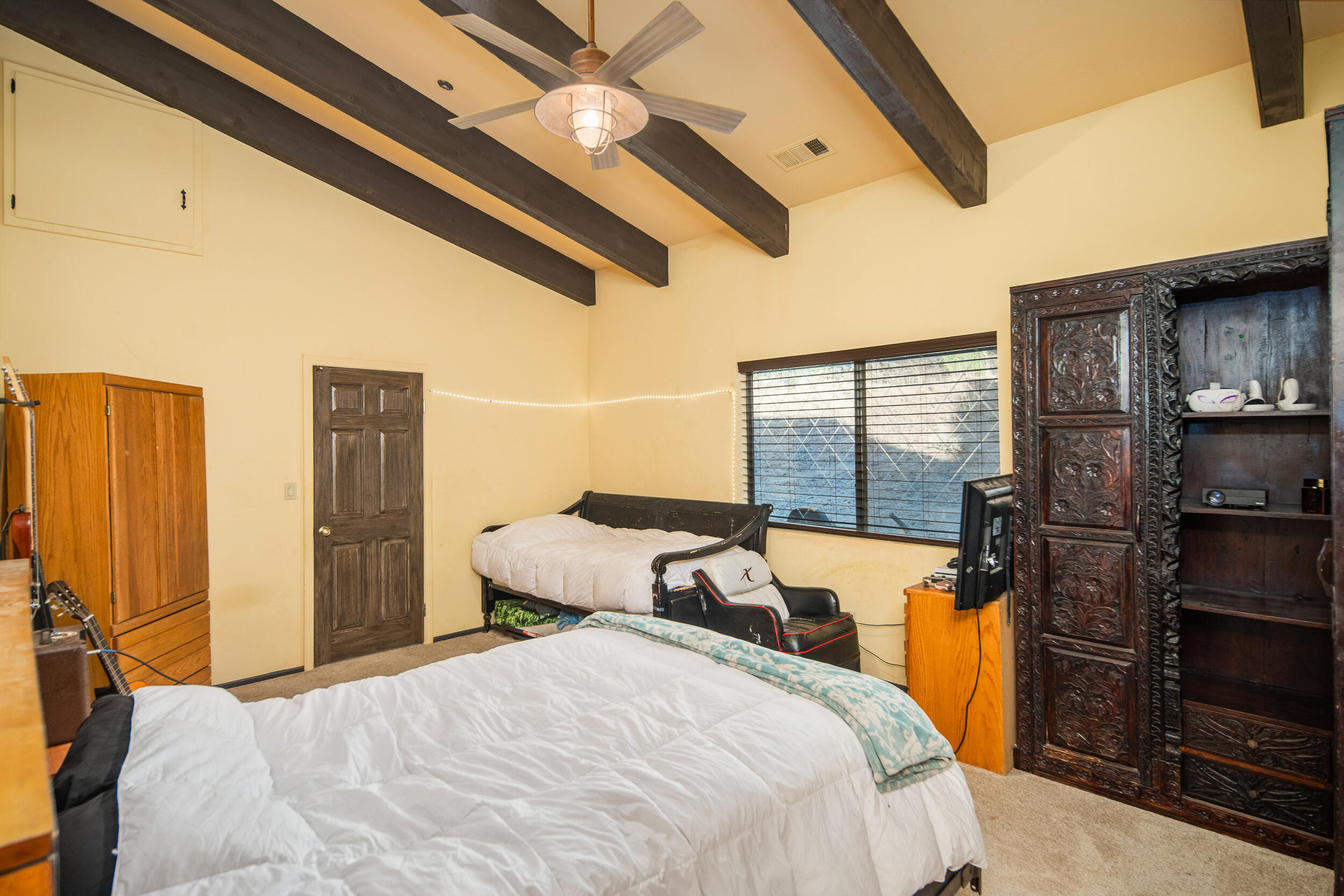 20718 Darsy Road Tehachapi, CA 93561 - Photo 36 of 64 a bedroom with a bed dresser and a floor to ceiling window