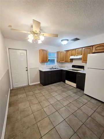 a kitchen with stainless steel appliances a stove a refrigerator and cabinets