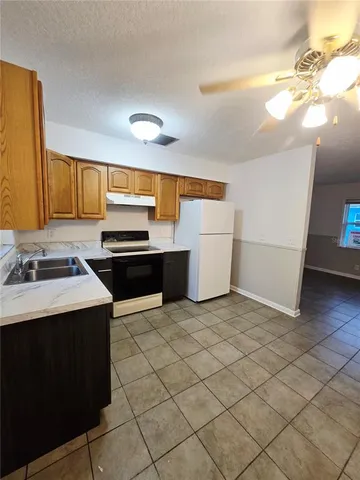 a kitchen that has a sink and a stove