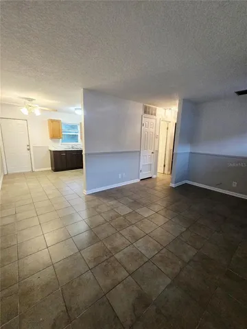 a view of a livingroom with wooden floor and a sink