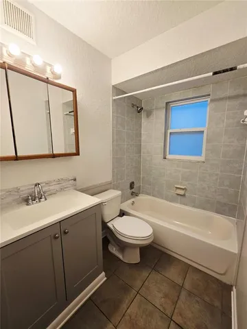 a bathroom with a toilet a sink and bathtub