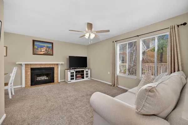 a living room with furniture a fireplace and a flat screen tv