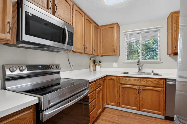 a kitchen with a sink stove and microwave