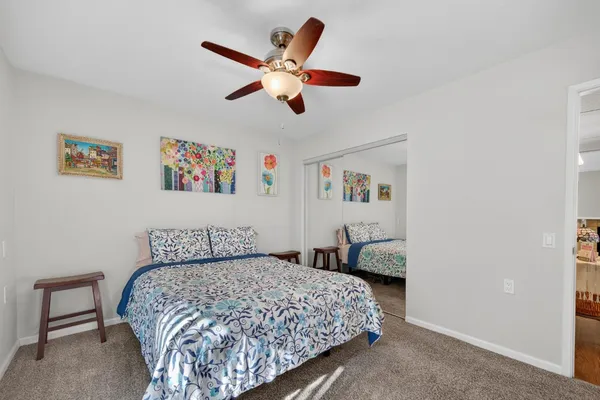 a bedroom with a large bed and a chandelier