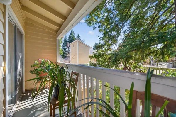 a view of balcony with wooden floor and flowers