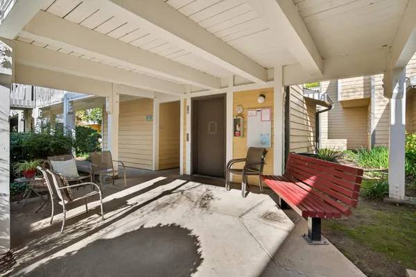 a building outdoor space with patio furniture and potted plants