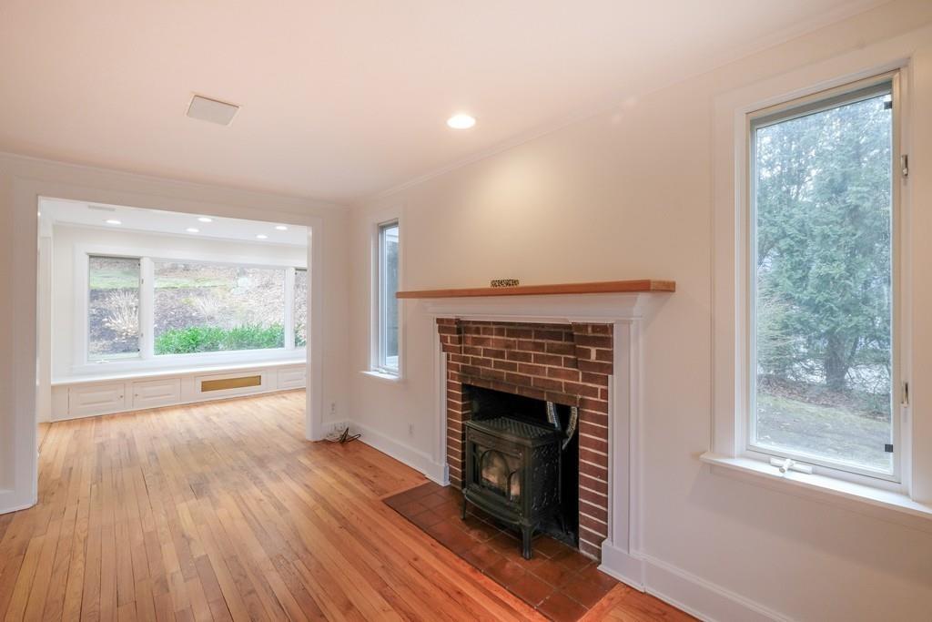 53 Moore Road Wayland, MA 01778 - Photo 12 of 27 a view of empty room with wooden floor and a fireplace