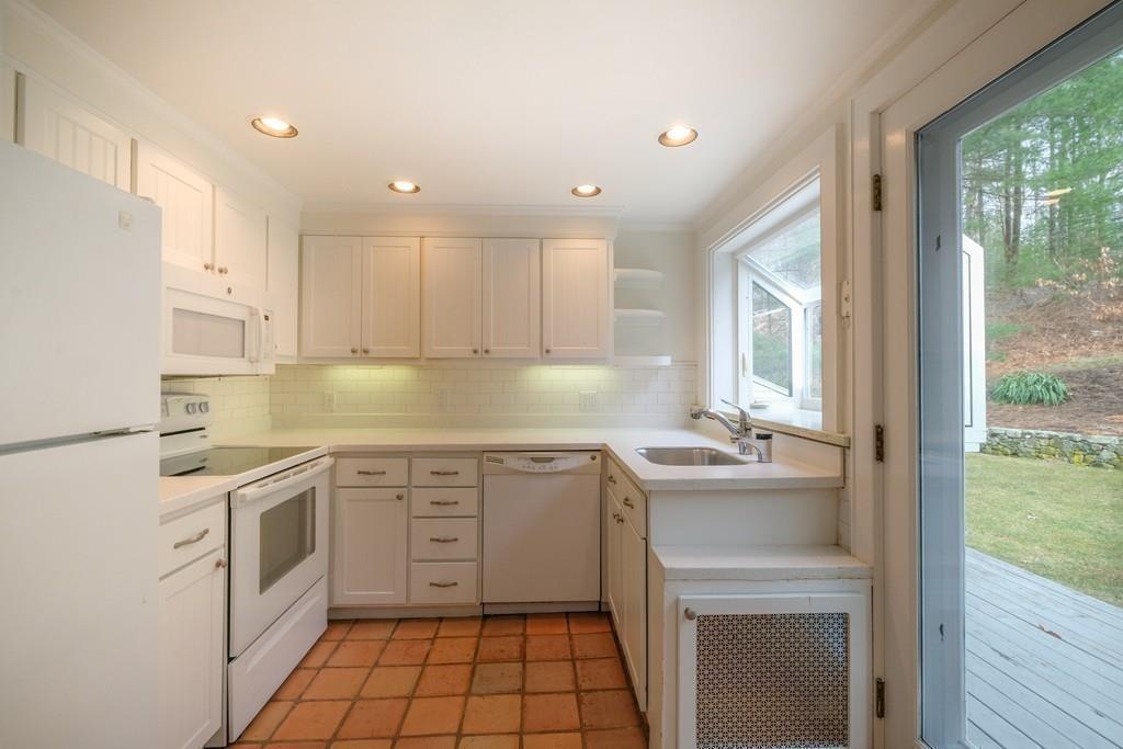 53 Moore Road Wayland, MA 01778 - Photo 13 of 27 a kitchen with a sink stove and cabinets