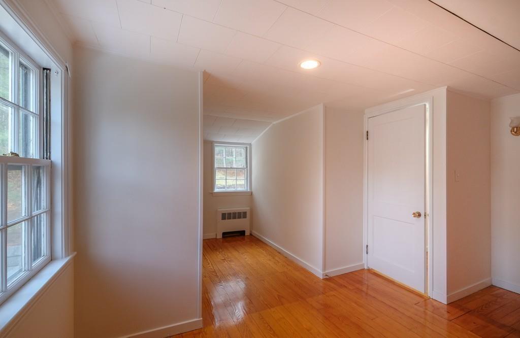 53 Moore Road Wayland, MA 01778 - Photo 16 of 27 an empty room with wooden floor and a window
