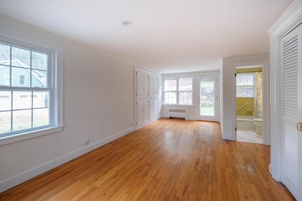 53 Moore Road Wayland, MA 01778 - Photo 7 of 27 an empty room with wooden floor and windows