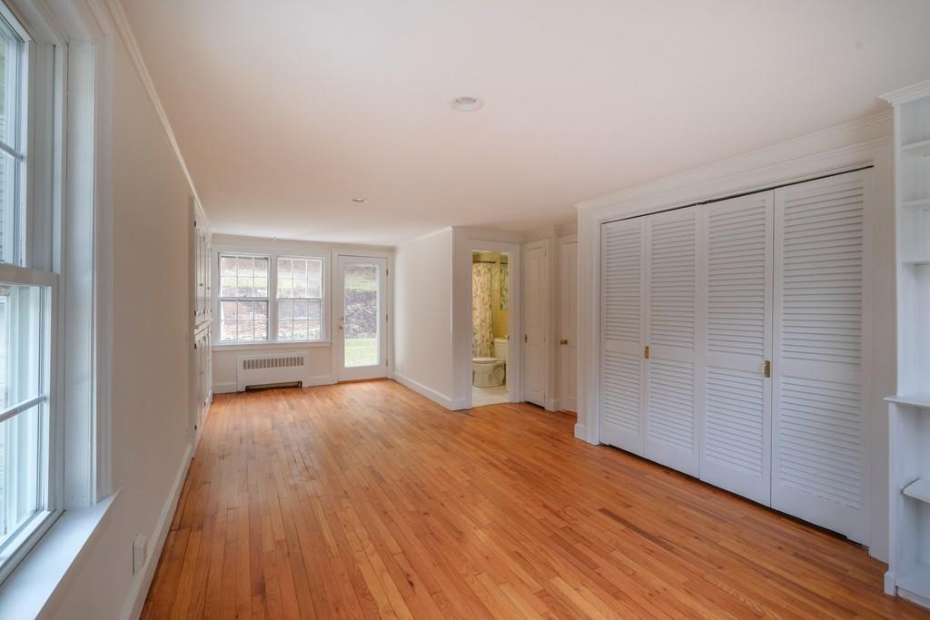 53 Moore Road Wayland, MA 01778 - Photo 8 of 27 a view of an empty room with wooden floor and a window
