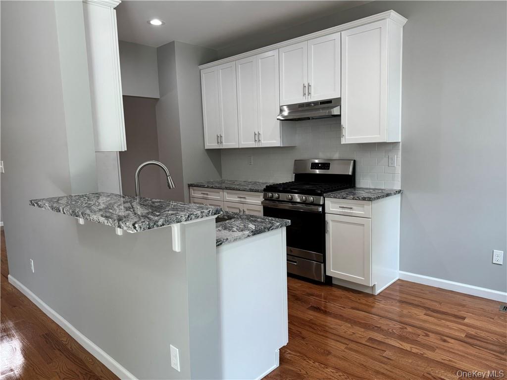 16 Pinto Road Middletown, NY 10941 - Photo 10 of 36 Kitchen with white cabinetry, stainless steel gas range oven, and dark hardwood / wood-style flooring
