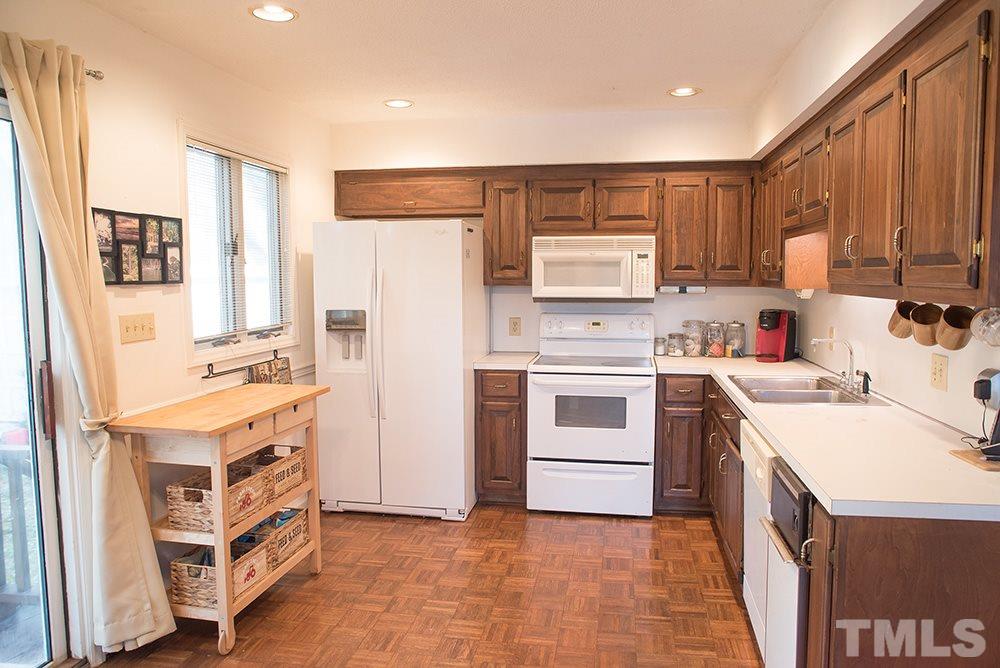 313 Fishermans Point Road Roxboro, NC 27574 - Photo 13 of 25 a kitchen with a stove a sink and a refrigerator