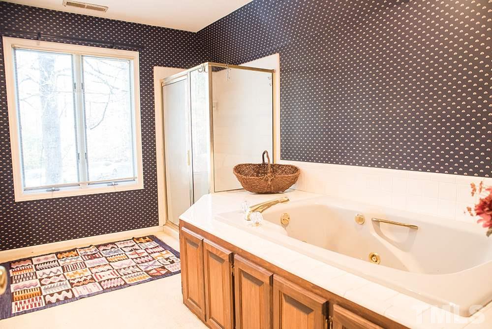 313 Fishermans Point Road Roxboro, NC 27574 - Photo 23 of 25 a bathroom with a bathtub and sink