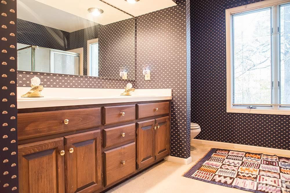 313 Fishermans Point Road Roxboro, NC 27574 - Photo 24 of 25 a bathroom with a sink a vanity and a mirror