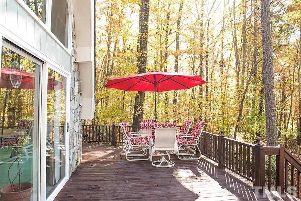 313 Fishermans Point Road Roxboro, NC 27574 - Photo 9 of 25 a view of a balcony with wooden floor and umbrella