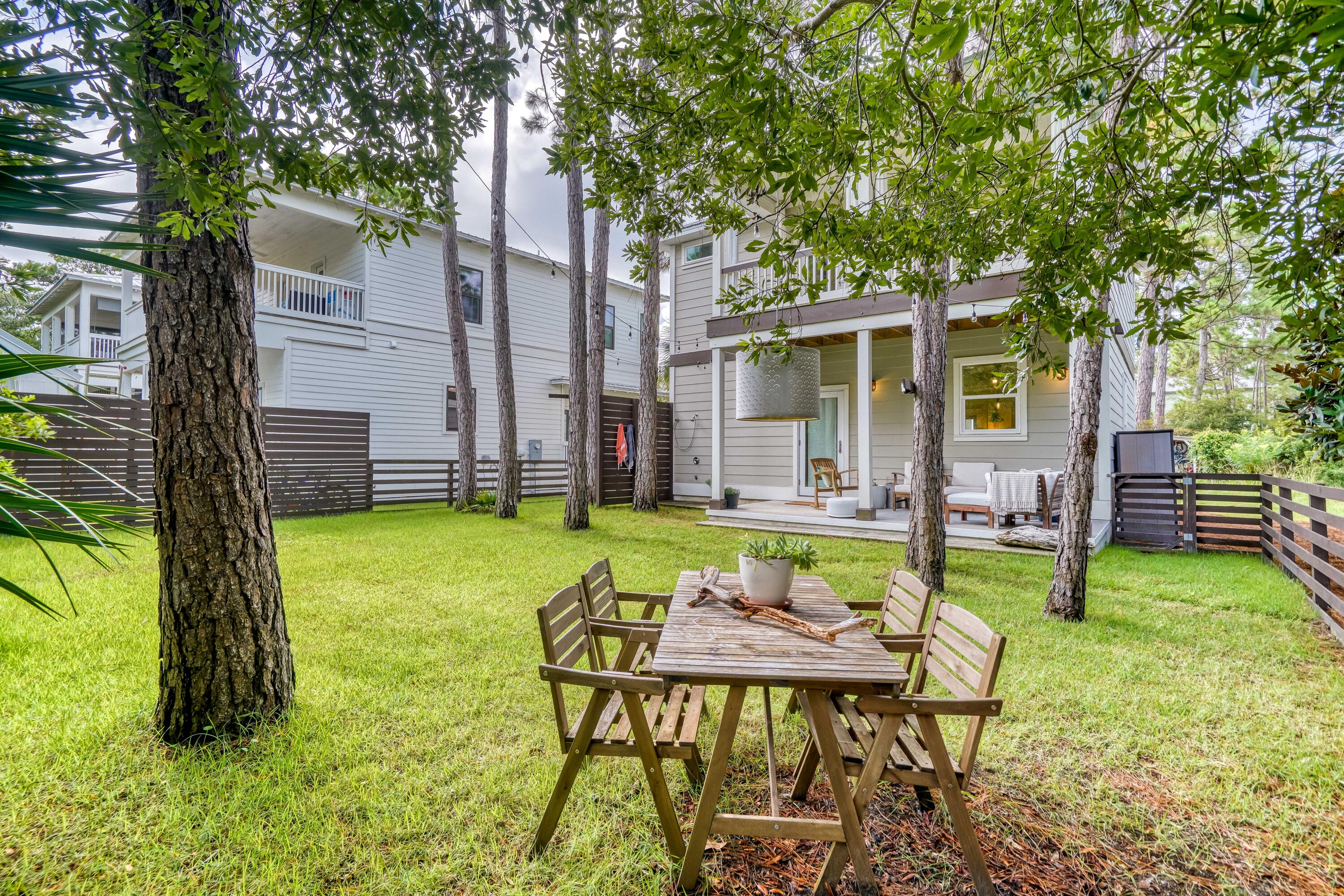 100 Snapper Street Santa Rosa Beach, FL 32459 - Photo 27 of 35 a backyard of a house with barbeque oven table and chairs