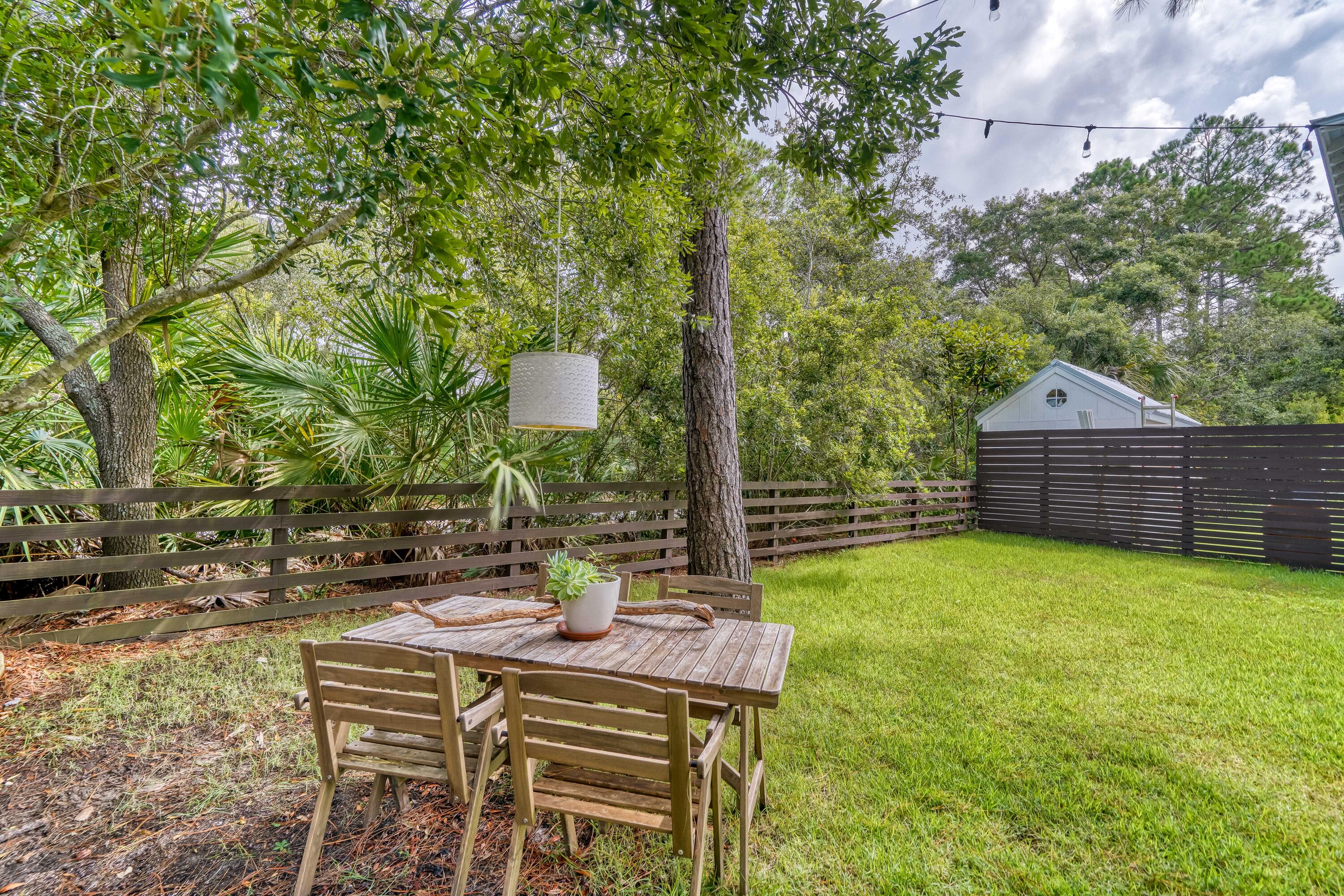 100 Snapper Street Santa Rosa Beach, FL 32459 - Photo 28 of 35 a backyard of a house with table and chairs