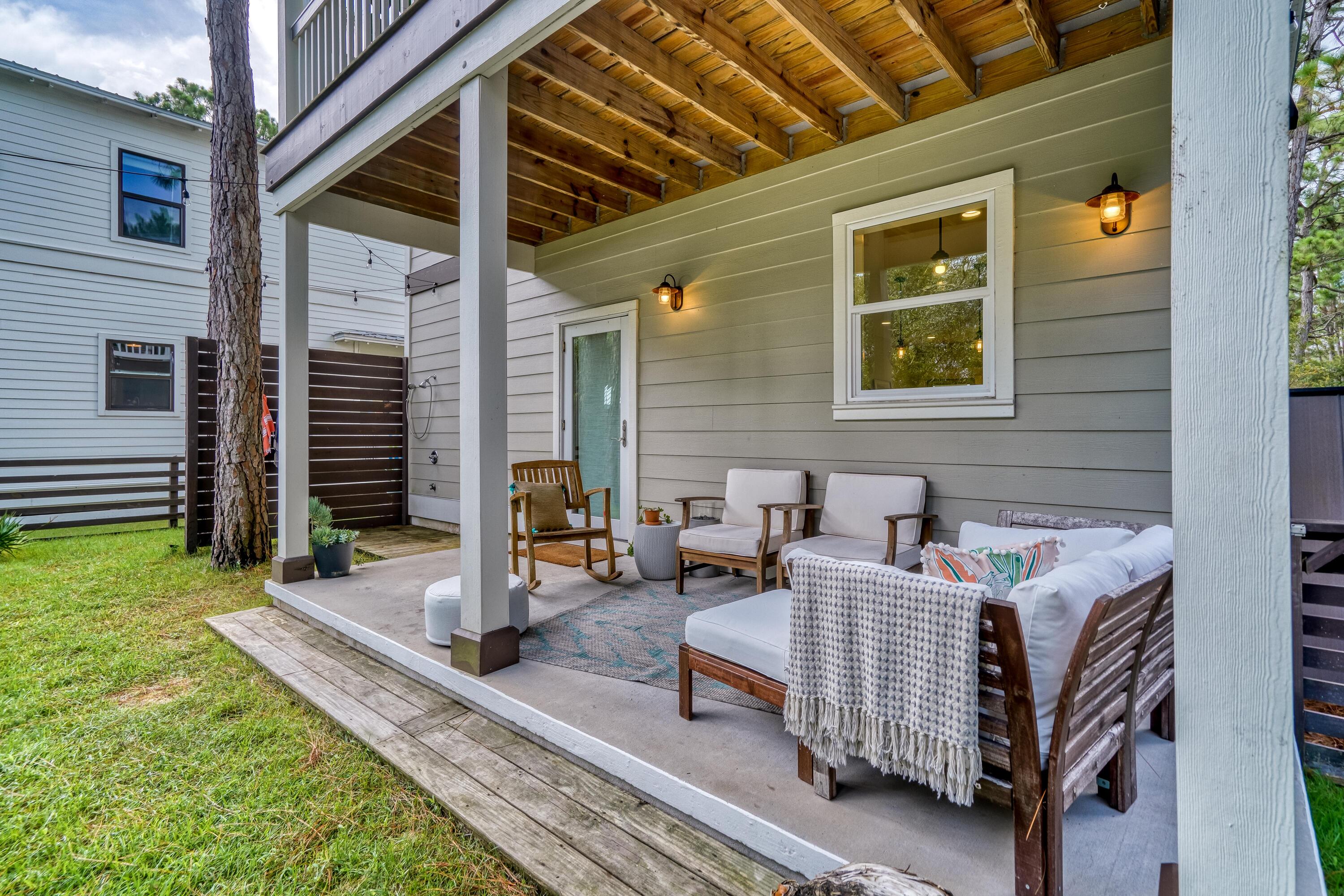 100 Snapper Street Santa Rosa Beach, FL 32459 - Photo 29 of 35 a outdoor living space with patio furniture and a garden