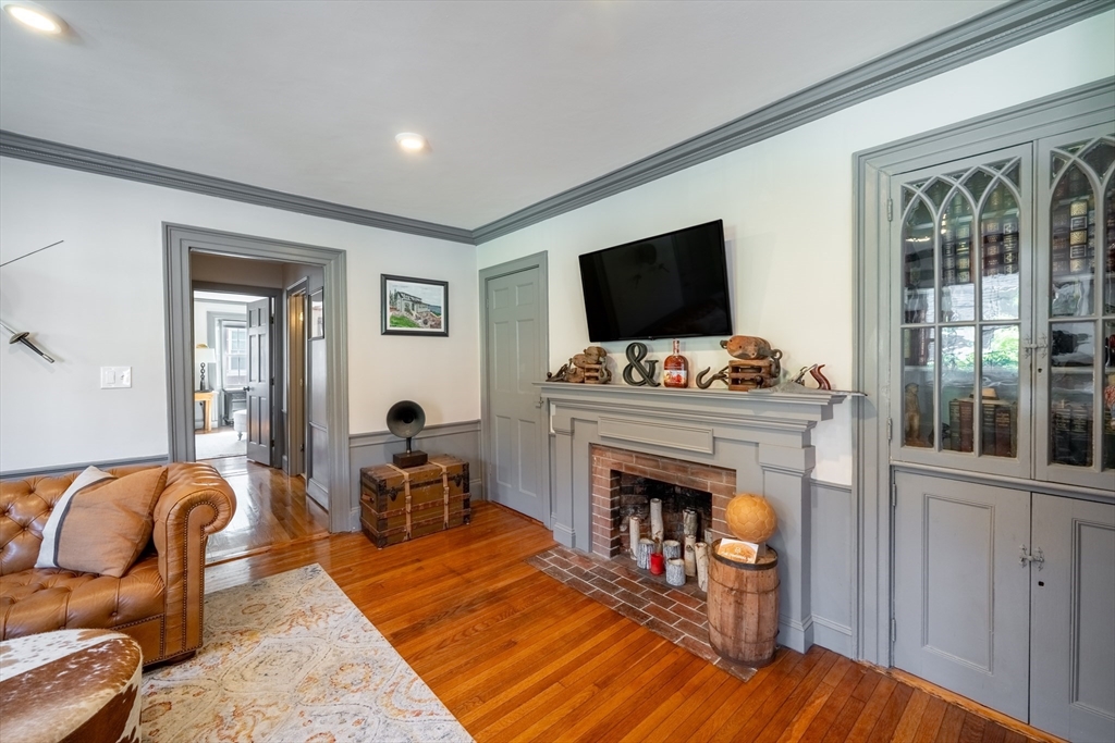 8 Williams Street, Unit E1 Salem, MA 01970 - Photo 11 of 30 a living room with furniture a flat screen tv and a fireplace