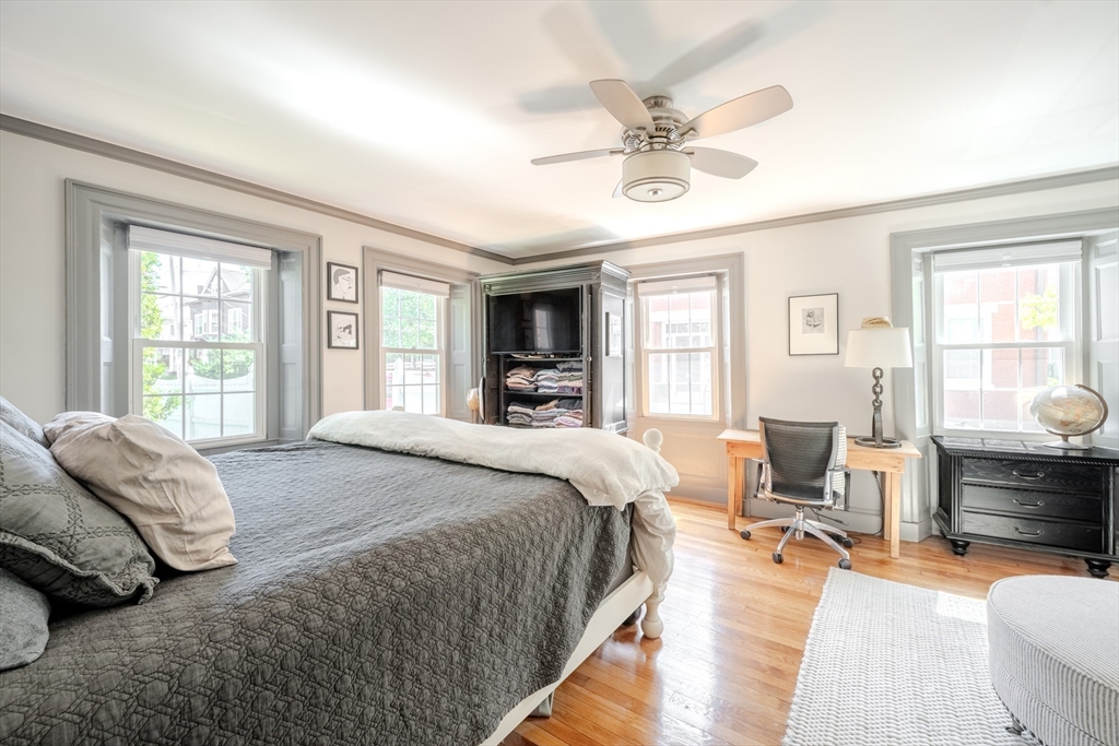 8 Williams Street, Unit E1 Salem, MA 01970 - Photo 12 of 30 a spacious bedroom with a bed a couch and large windows