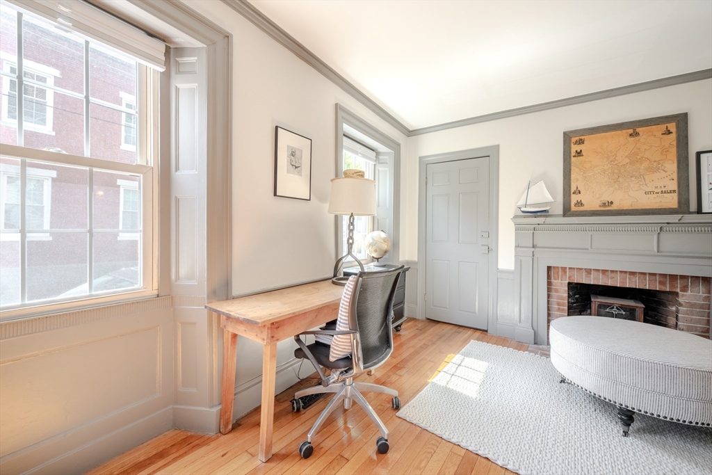 8 Williams Street, Unit E1 Salem, MA 01970 - Photo 15 of 30 a living room with furniture a window and a fireplace