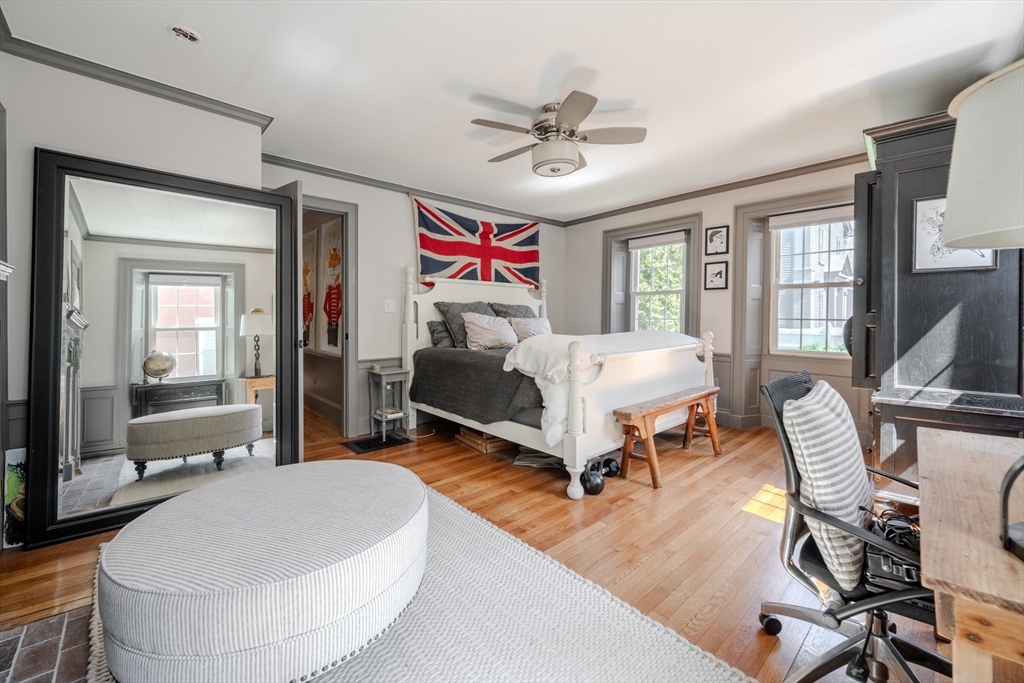 8 Williams Street, Unit E1 Salem, MA 01970 - Photo 16 of 30 a bedroom with a bed and a chandelier