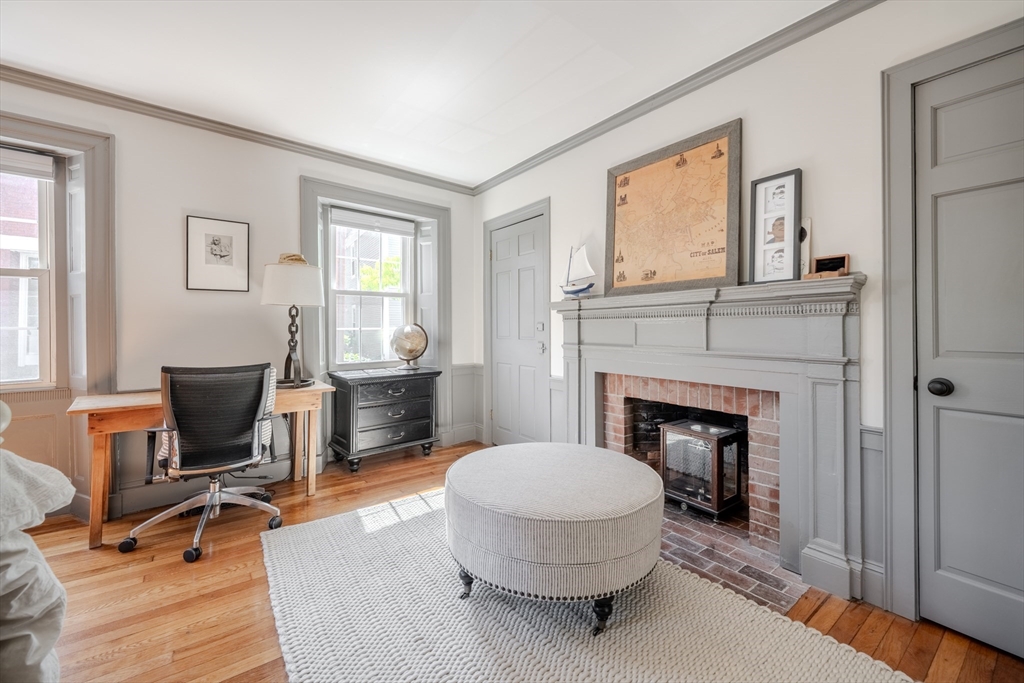 8 Williams Street, Unit E1 Salem, MA 01970 - Photo 17 of 30 a living room with furniture a fireplace and a window