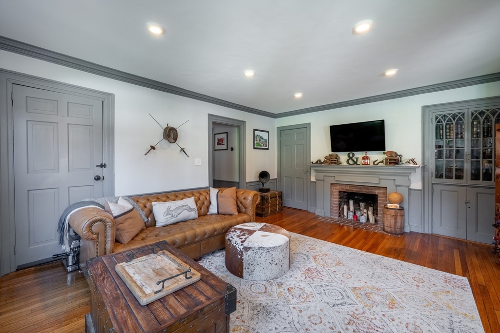 8 Williams Street, Unit E1 Salem, MA 01970 - Photo 4 of 30 a living room with furniture a fireplace and flat screen tv