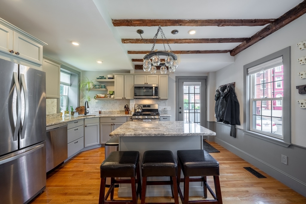8 Williams Street, Unit E1 Salem, MA 01970 - Photo 5 of 30 a kitchen with stainless steel appliances granite countertop a refrigerator and a stove top oven