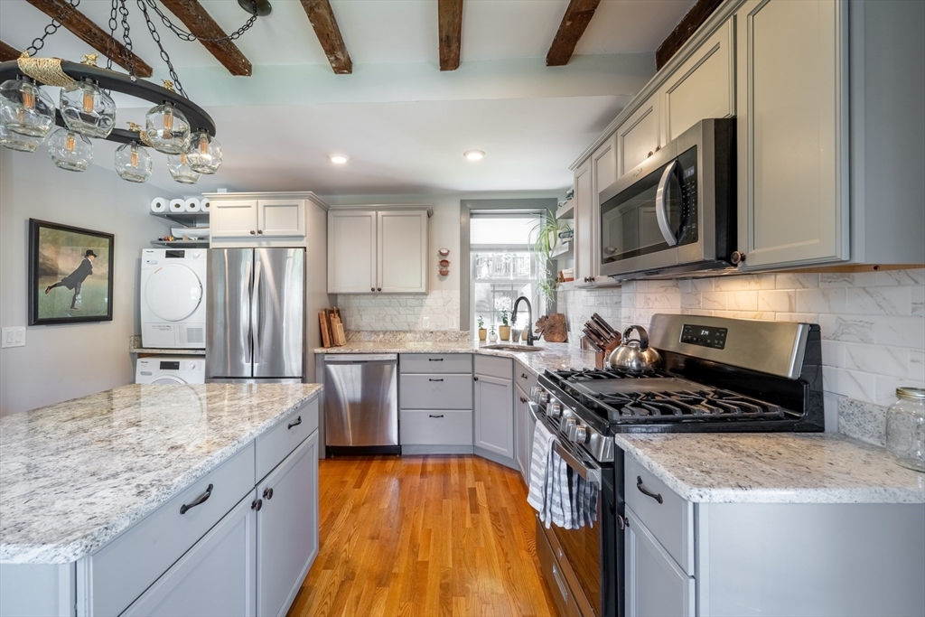8 Williams Street, Unit E1 Salem, MA 01970 - Photo 7 of 30 a kitchen with a sink stove top oven and refrigerator