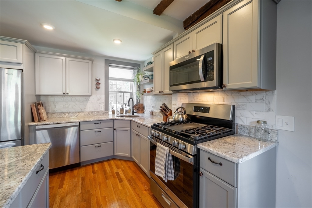 8 Williams Street, Unit E1 Salem, MA 01970 - Photo 9 of 30 a kitchen with a stove a sink and a microwave