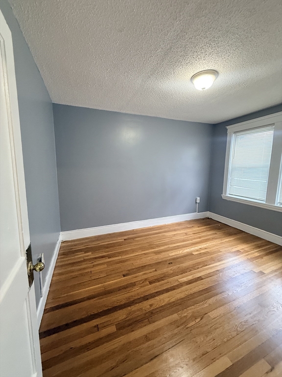 39 Wentworth Street, Unit 3 Boston, MA 02124 - Photo 11 of 19 a view of empty room with wooden floor