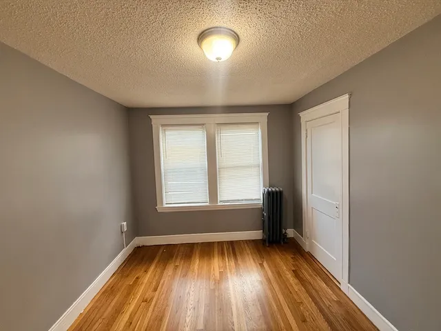 a view of room with wooden floor