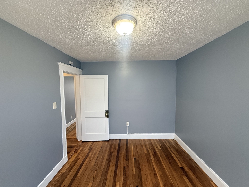 39 Wentworth Street, Unit 3 Boston, MA 02124 - Photo 13 of 19 a view of room with wooden floor