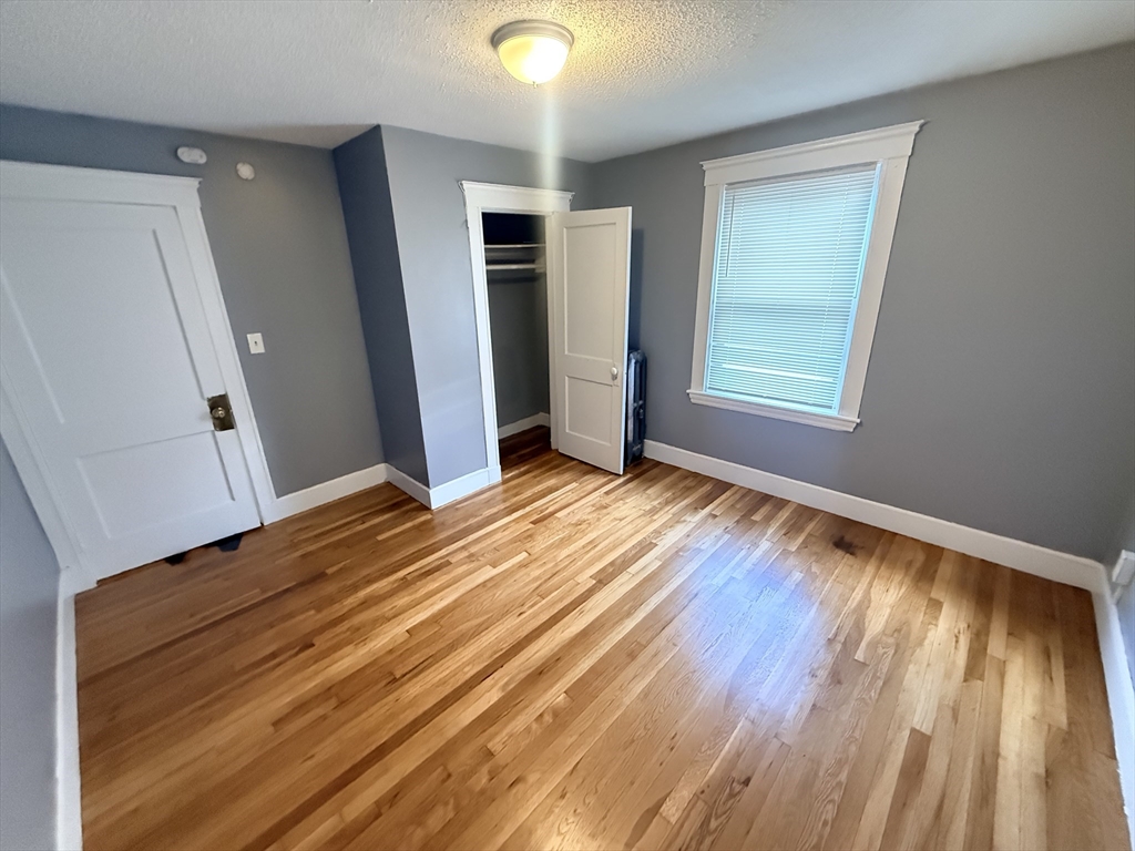 39 Wentworth Street, Unit 3 Boston, MA 02124 - Photo 14 of 19 a view of a room with wooden floor and window