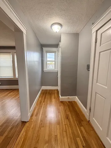 a view of a room with wooden floor and white walls