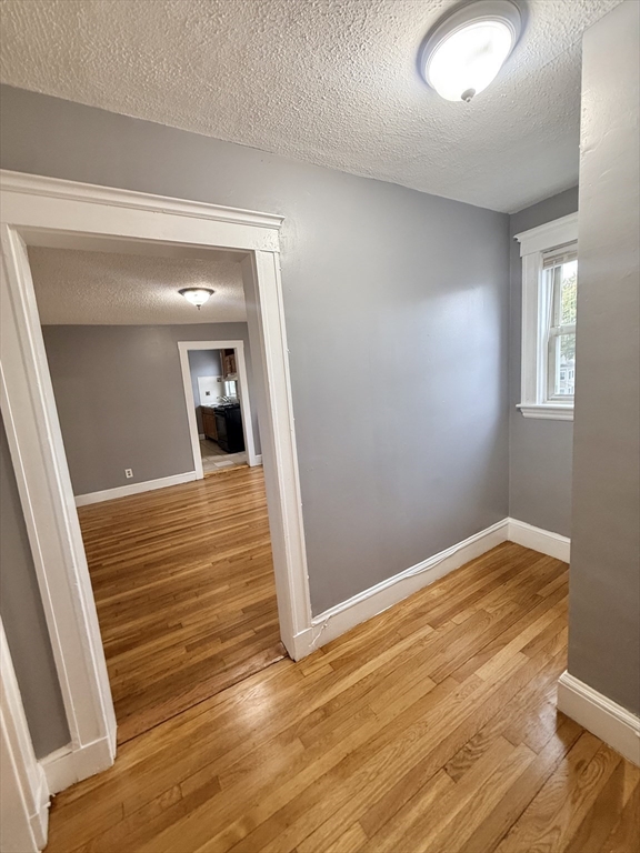 39 Wentworth Street, Unit 3 Boston, MA 02124 - Photo 3 of 19 a view of a room with wooden floor and white walls