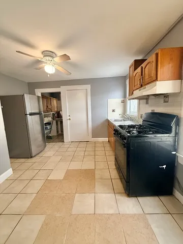 a view of a kitchen with refrigerator and furniture