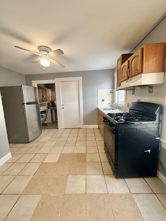 39 Wentworth Street, Unit 3 Boston, MA 02124 - Photo 4 of 19 a kitchen with stainless steel appliances granite countertop a refrigerator a stove and a sink with granite countertops